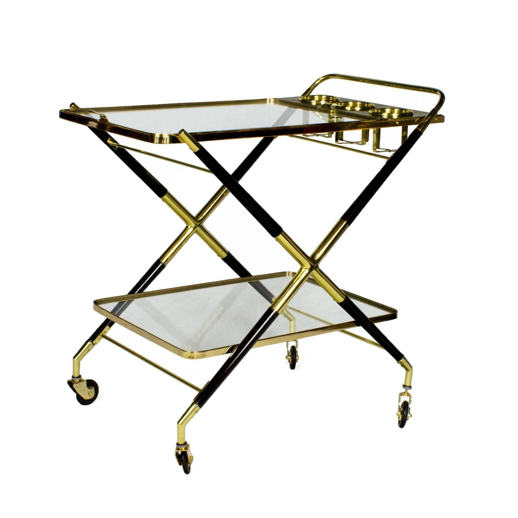 Splendid bar cart, stained beech wood, French polish. Polished brass and glass. Removable tray and bottles containers. Pivotant wheels.

Design: Cesare Lacca

Italy, circa 1950.