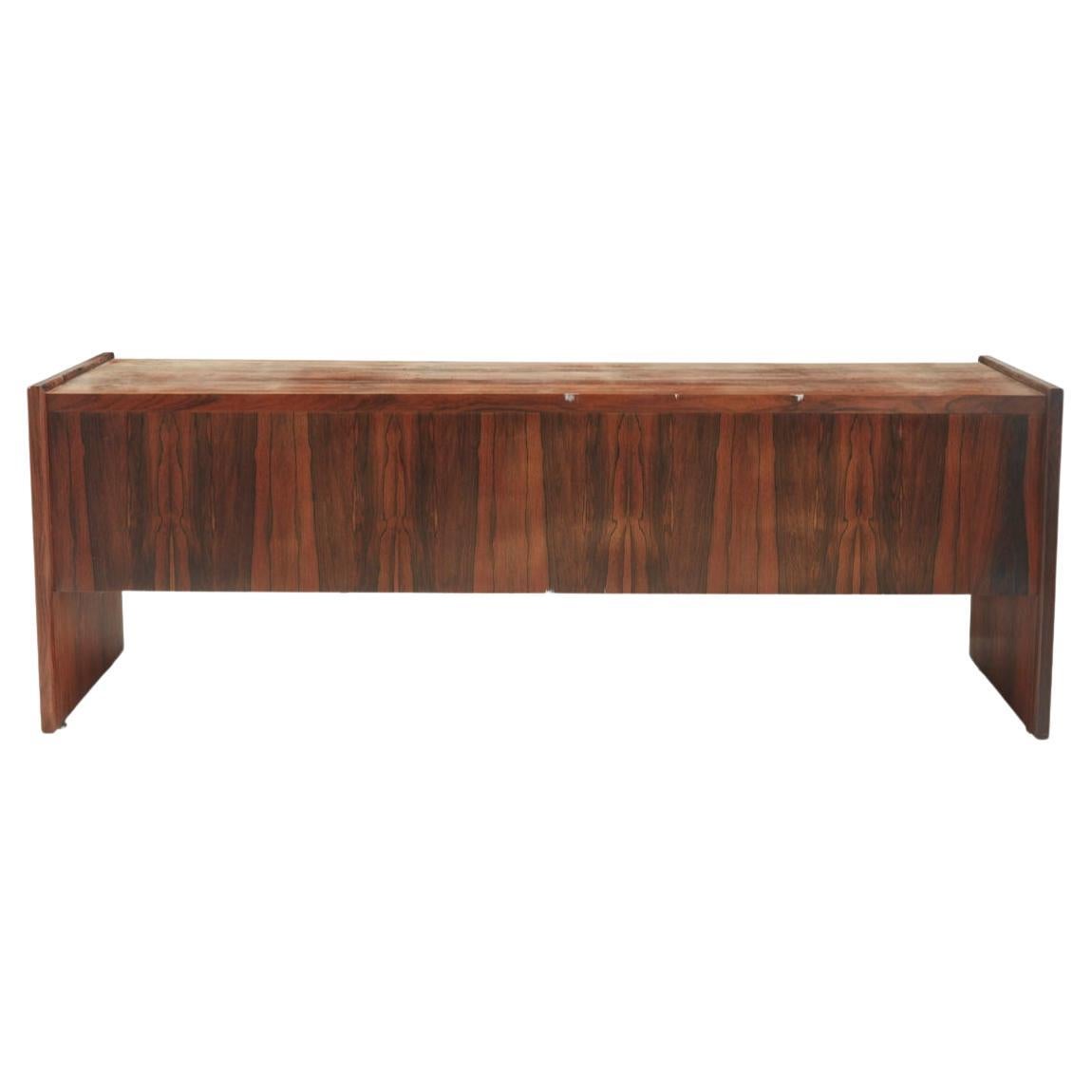 Beautiful Brazilian rosewood long low credenza  with 4 drawers and middle sliding doors. Amazing rosewood grain all around. Has vertical supports on each end with open space underneath. 

Measures 84” x 21” x 30” high 