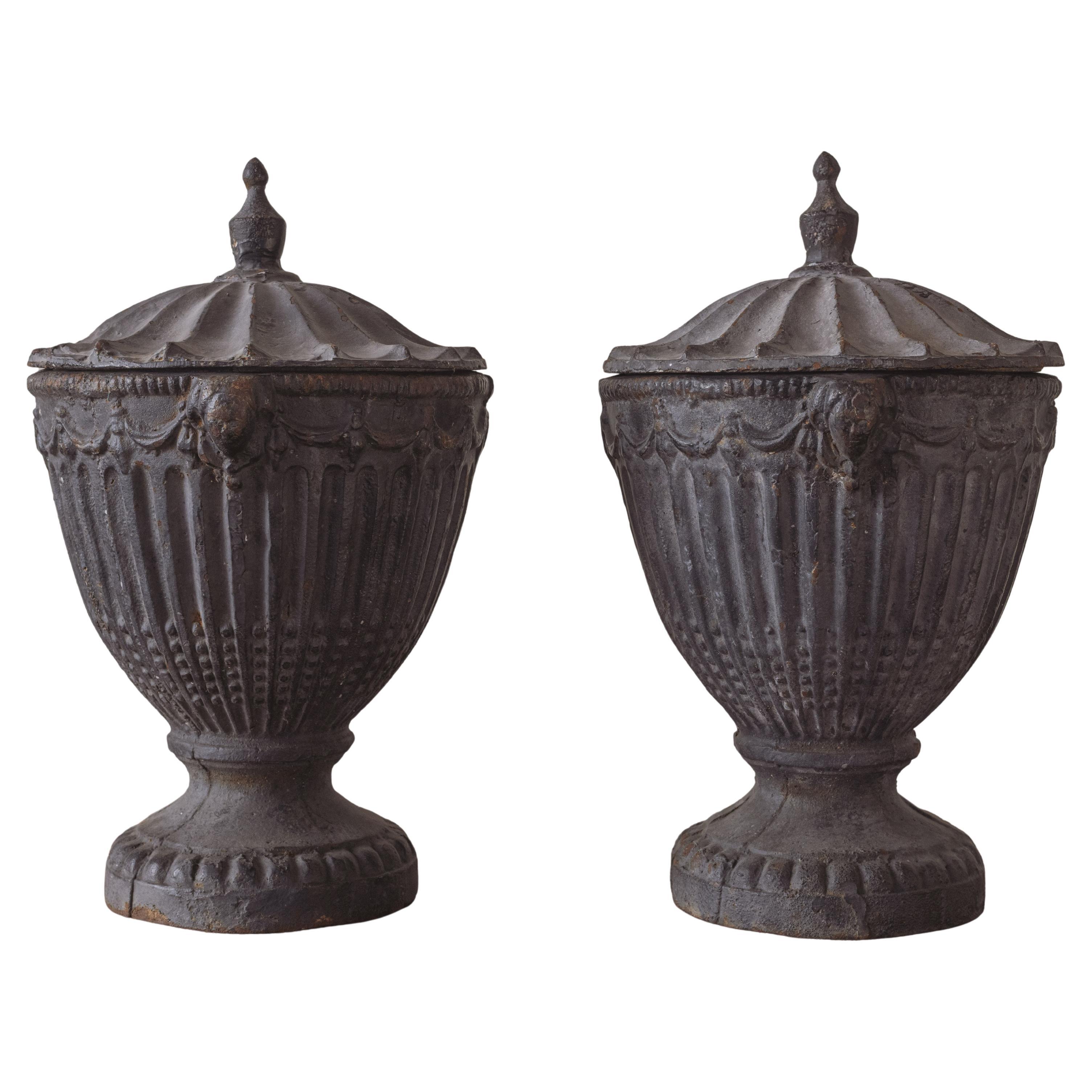 A Pair of Cast Iron Urns For Sale