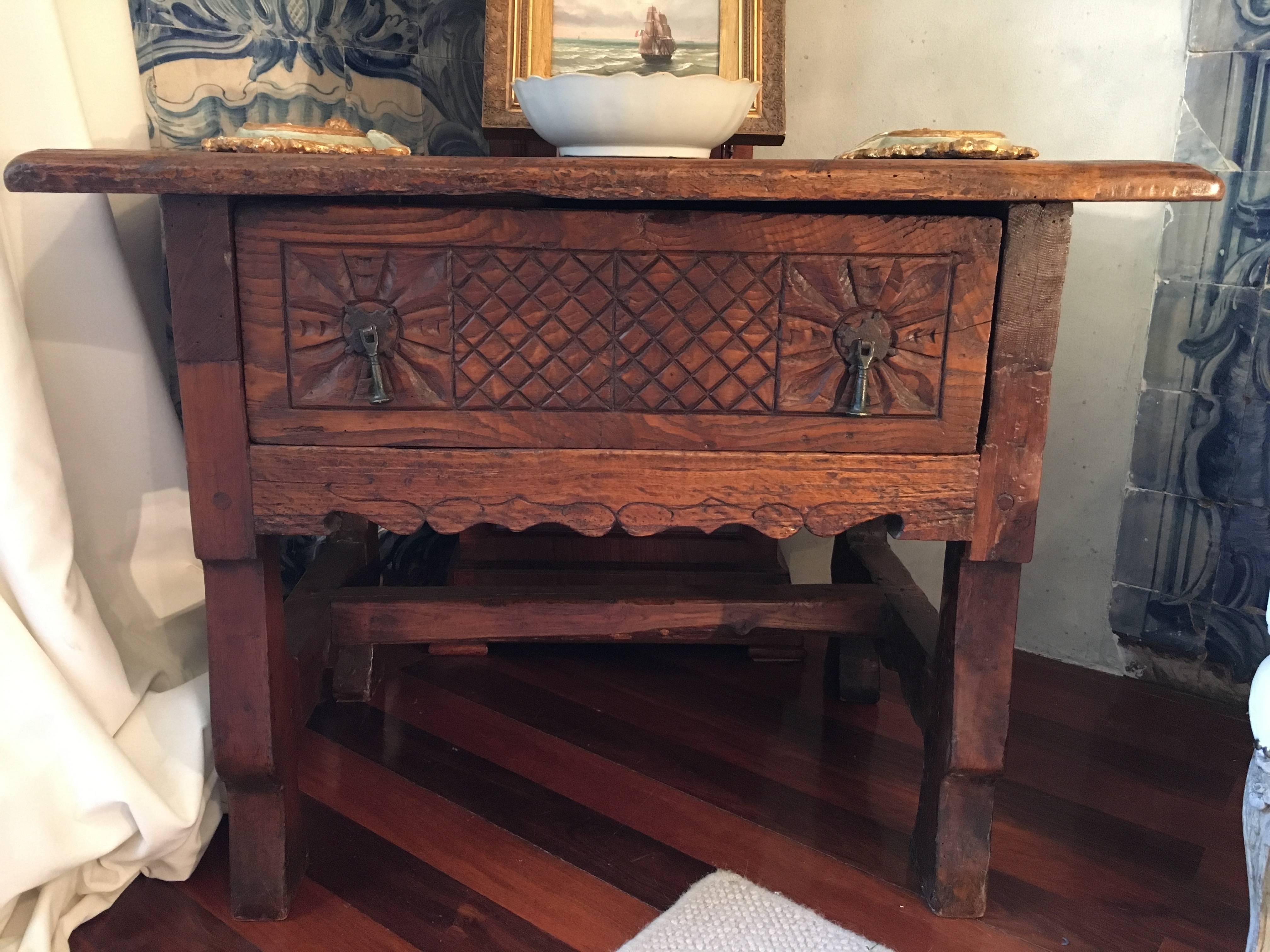 For sale on 1stDibs 17th century oak carved Portuguese side table with one drawer. The plain lines and simplicity was typical of this period, when the wood tended to play a more important role over the ormolu mounts.