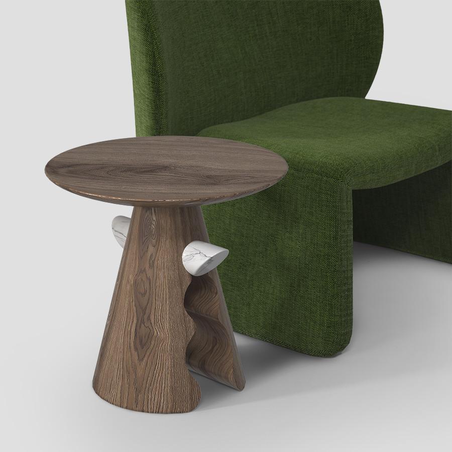 Designed by Unicuo, Cracker blends the flow of its curves with the strength of wood, creating a conical base that rises from within with soft, wavy shapes, ending in a perfect circle that holds a marble bar. This circle represents perfect balance,