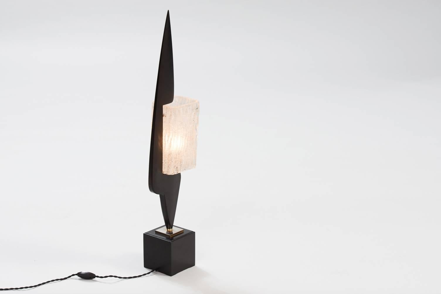 Black lacquered wood, glass and brass table lamp.