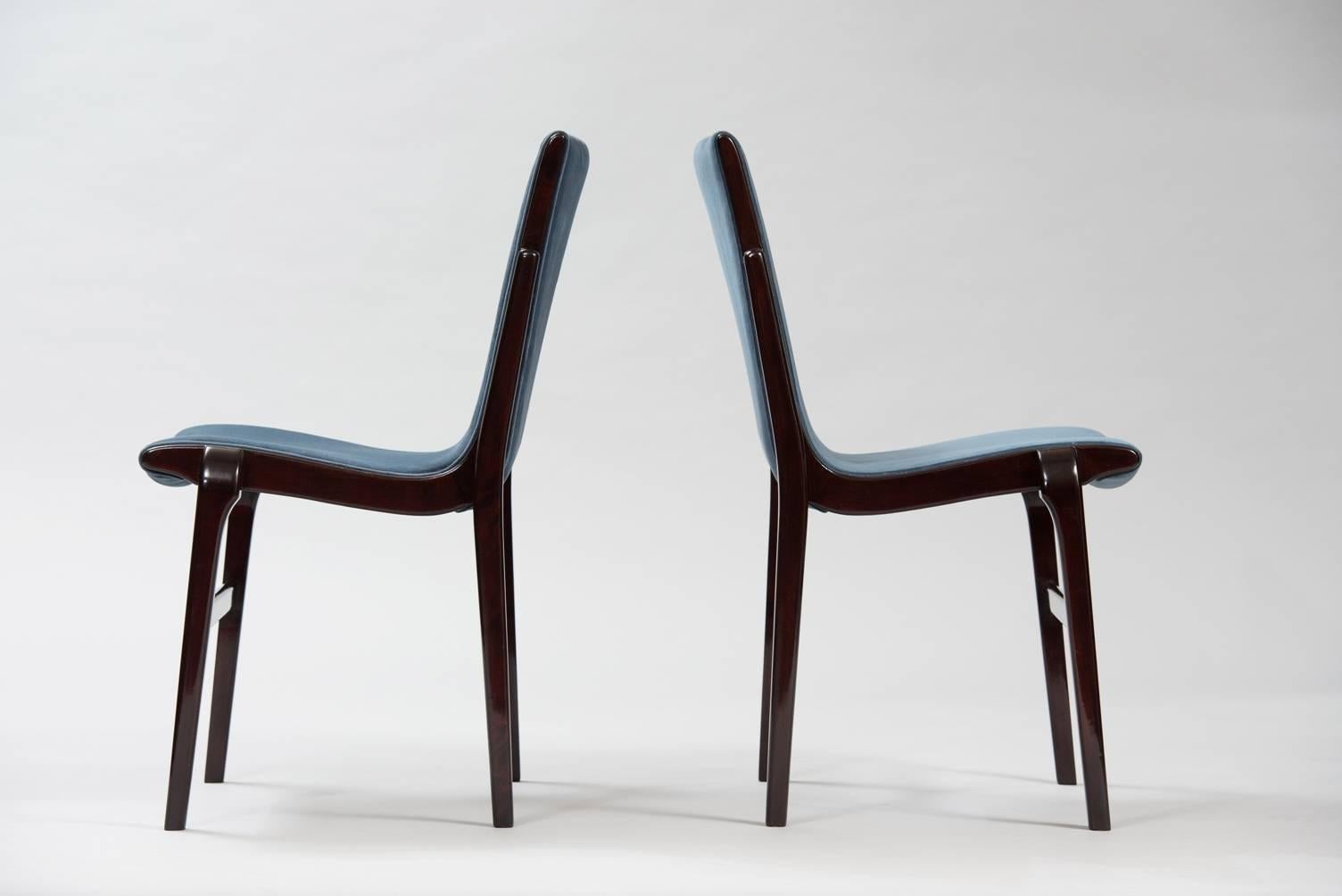 Set of ten darkened beech curved back dining chairs re-upholstered in blue velvet, “Kungsor” model.