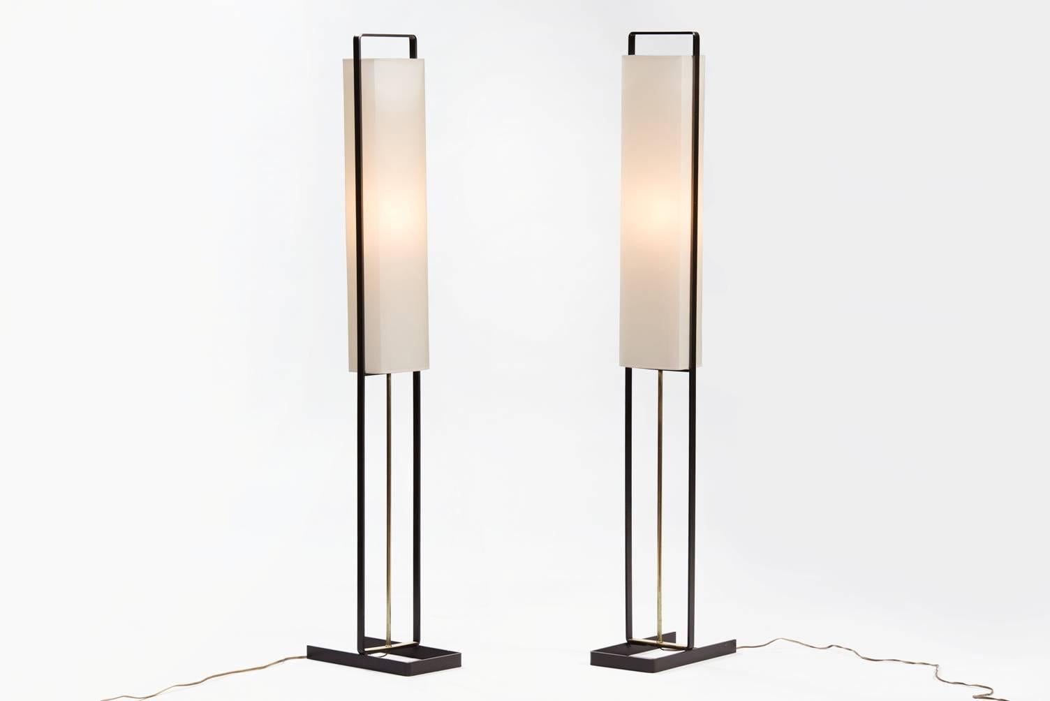 A pair of black painted iron and brass floor lamps, new parchment paper shades.
