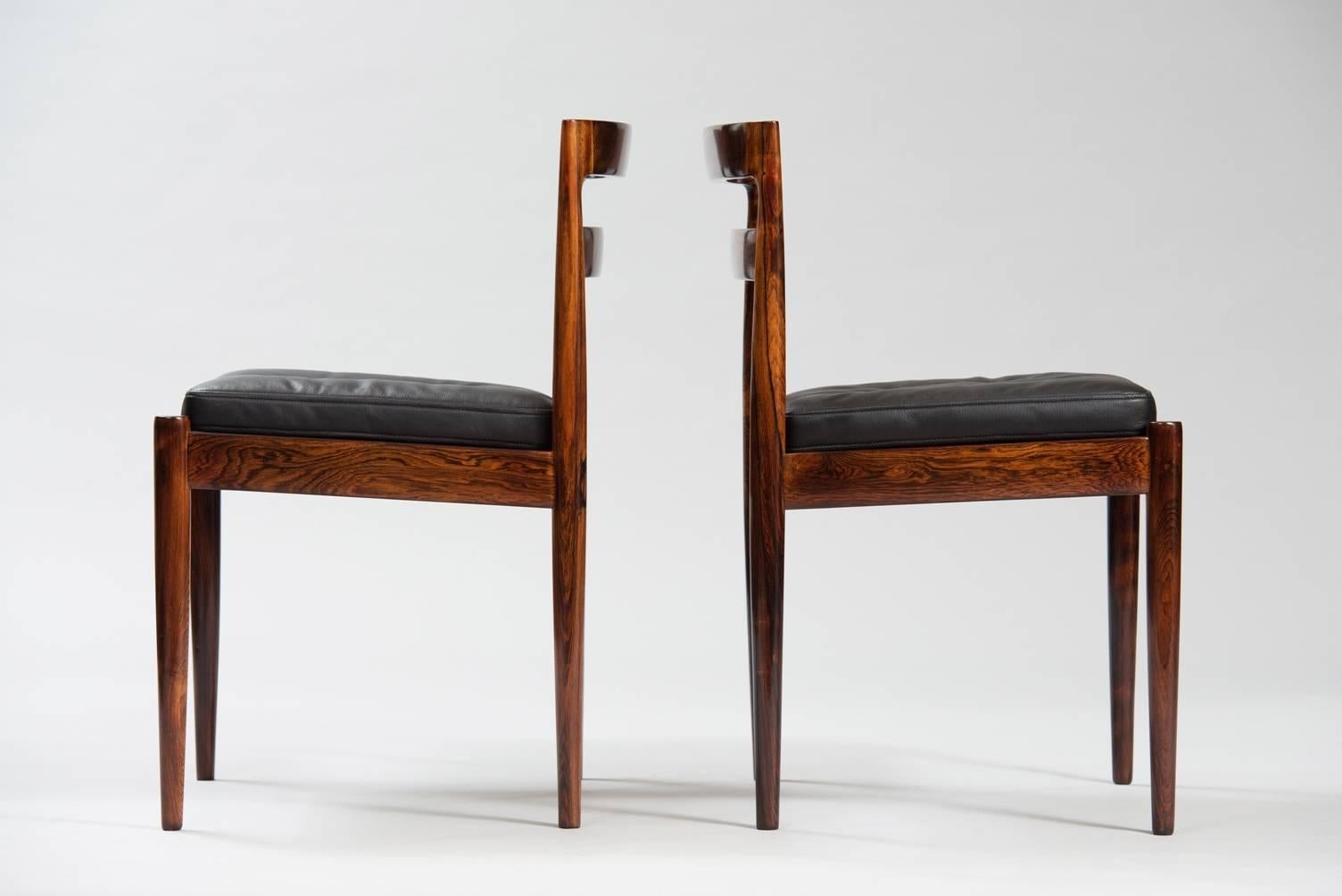 Set of eight massive rosewood dining chairs, model “301 Universe”, re-upholstered in black leather.
Producer: Magnus Olesen.