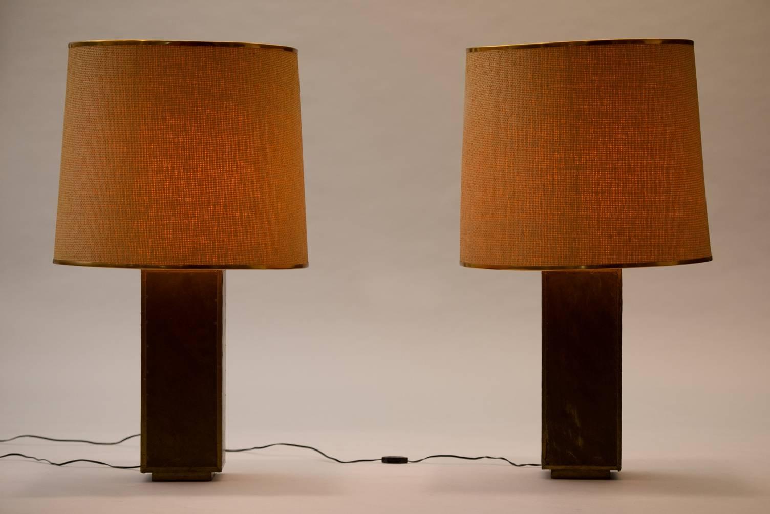 A pair of large brass table lamps, rattan shades with brass frames.
Signed R. Dubarry.