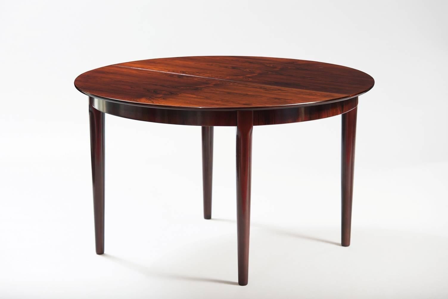 Rosewood extendible round dining table.
Measures: W. 325 125 cm (closed), D. 125 cm, H. 74 cm.
