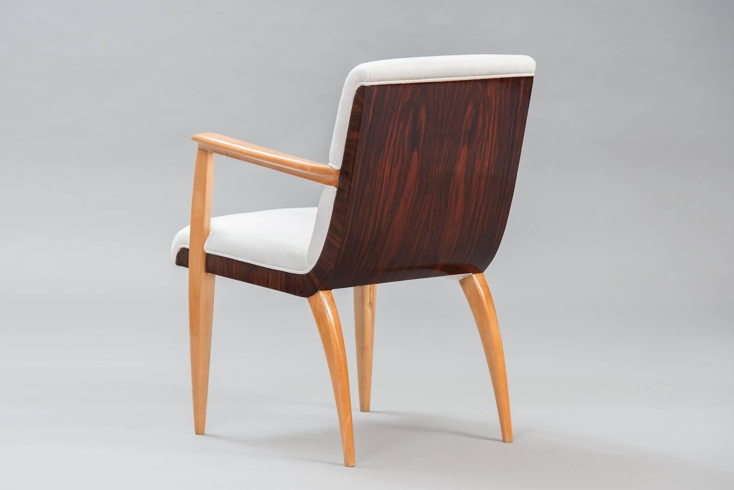 Rosewood and sycamore armchair, re-upholstered in ivory leather.