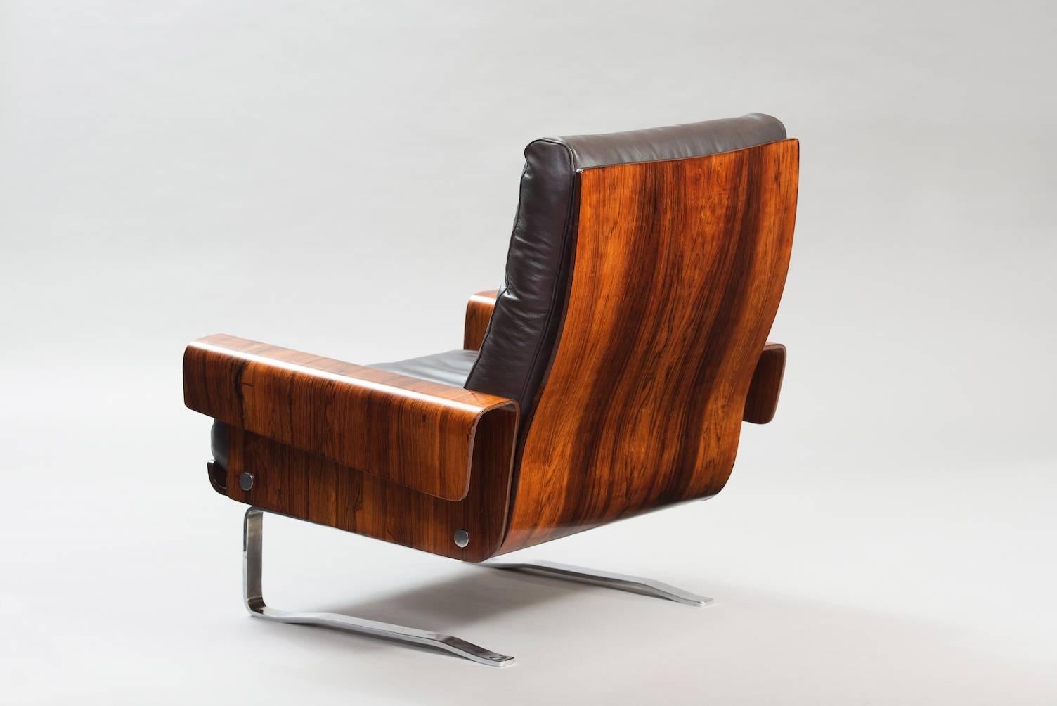 Rosewood and chrome armchair, re-upholstered in brown leather.