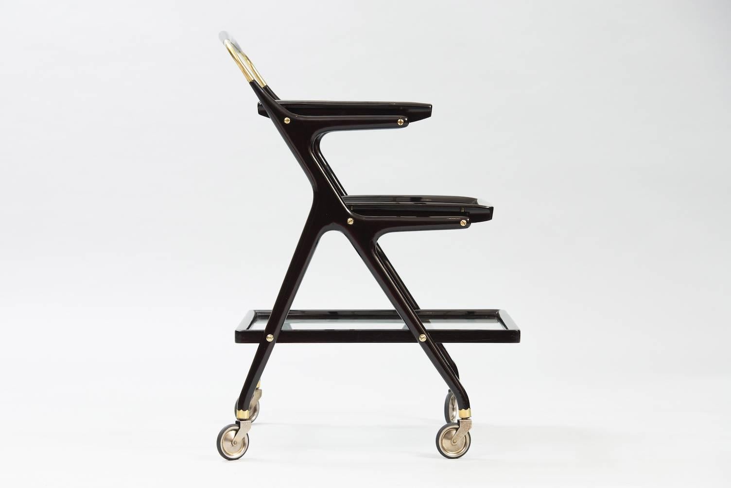 Three tear rolling cart in ebonized wood, brass and glass with two removable trays.
Producer: Cassina.