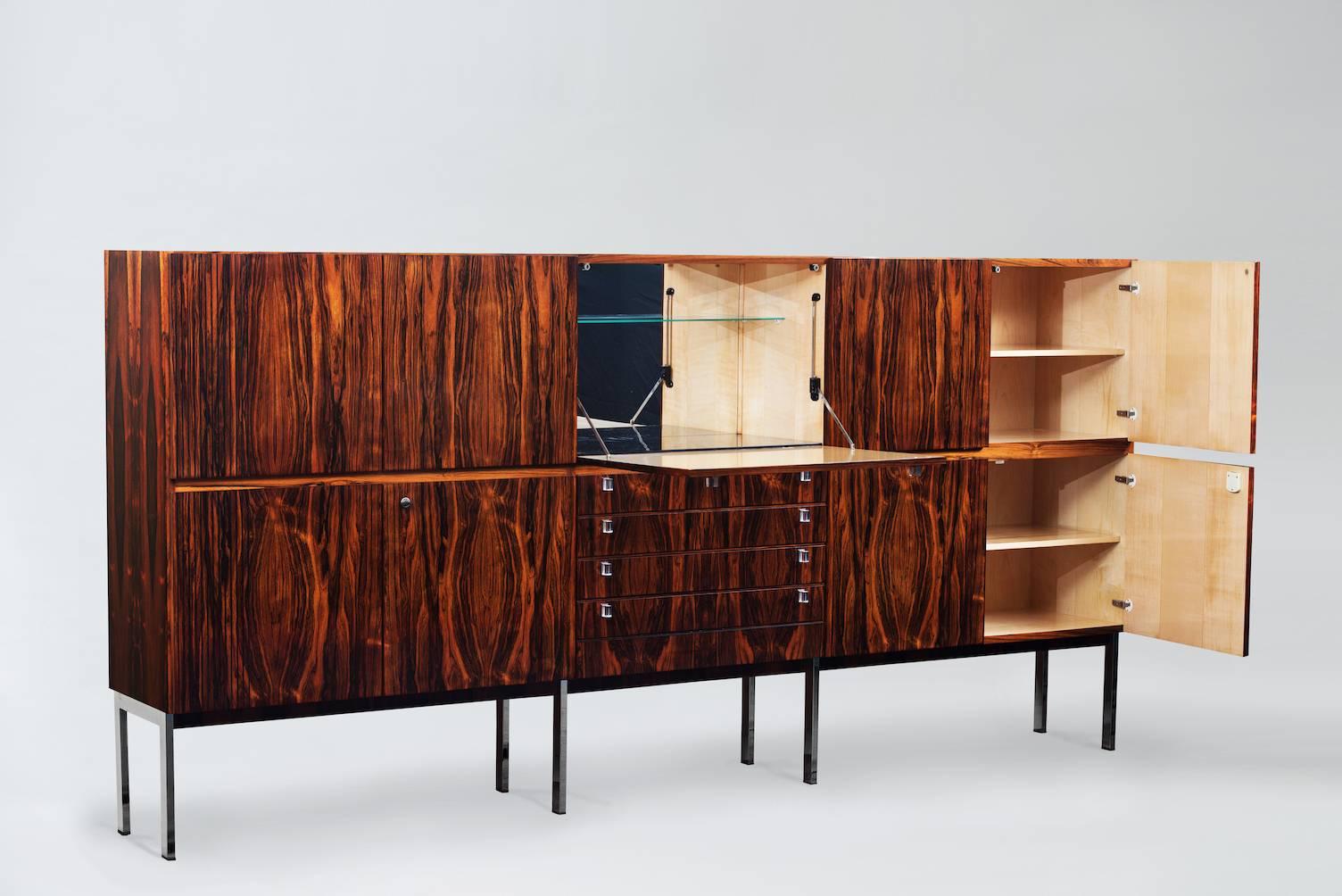 Large rosewood high board with eight doors, four drawers, and one bar compartment with folding panel, Lucite grips featuring chromed baseplates and chromed rectangular tubular steel lower frame.