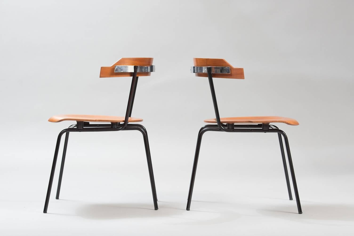 Set of four molded plywood with teak veneer dining chairs, black painted metal structure and a chrome frame in the back.