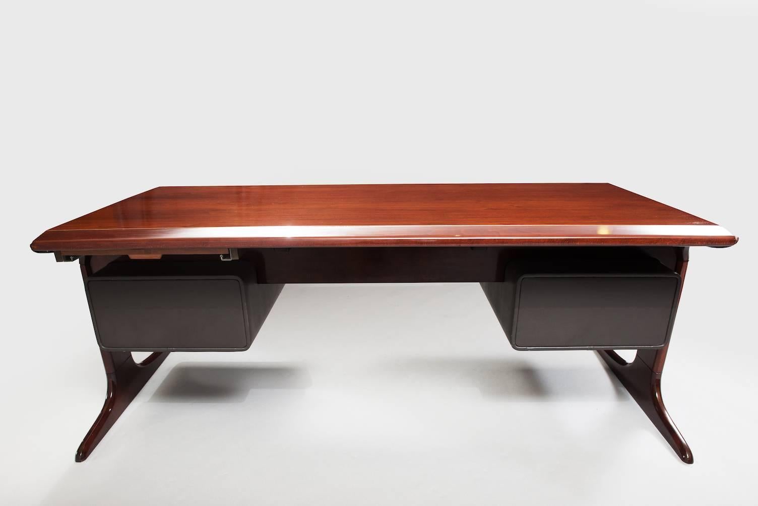 Walnut desk with two blocks upholstered in brown ecological skin, each one with two drawers.