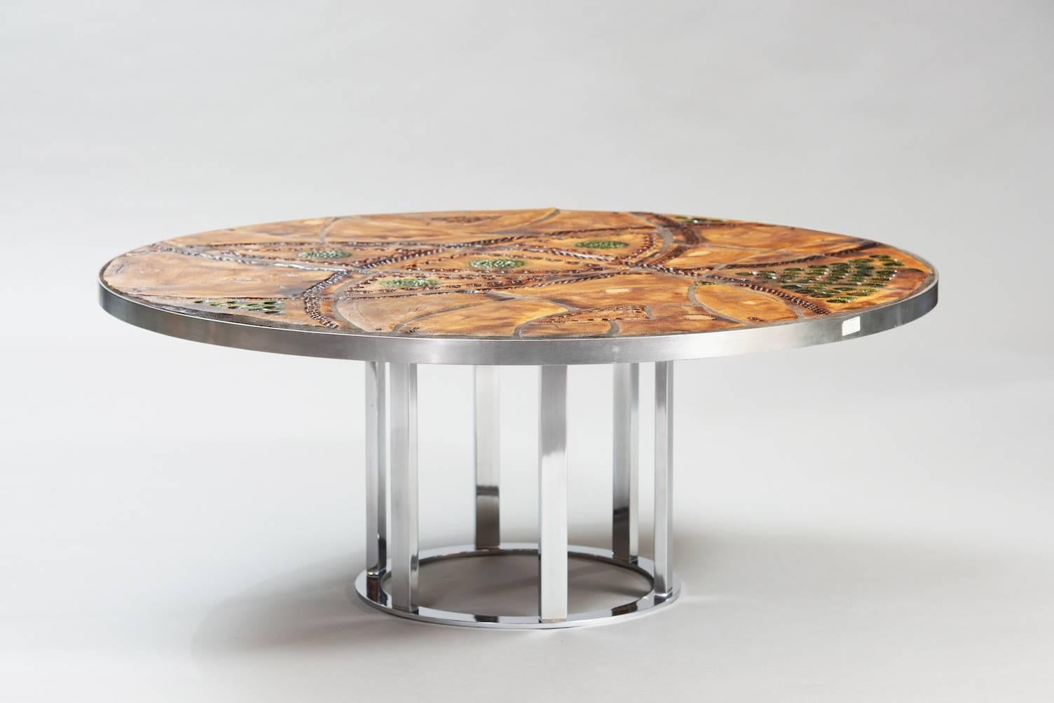 Circular coffee table with a steel frame and chrome base, glazed ceramic top.
Signed: Just Lichtenberg.