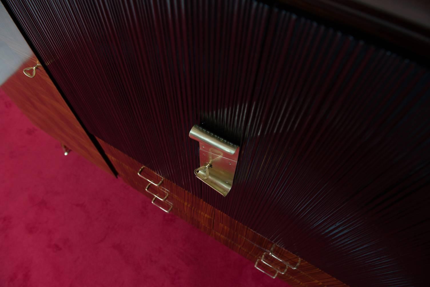 Rosewood cupboard or dry bar, brass hardware and a marble shelf on top.
Producer: Dassi & Figli.