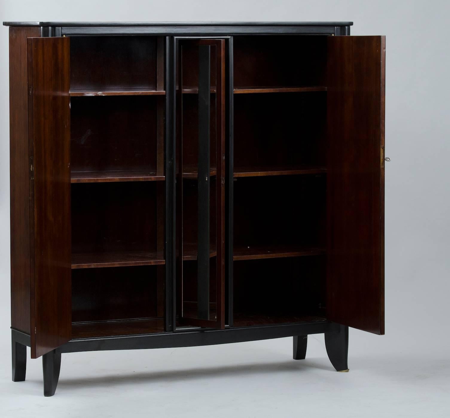 Art Deco rosewood wardrobe, with revolving centre mirror and a brass feminine figure.