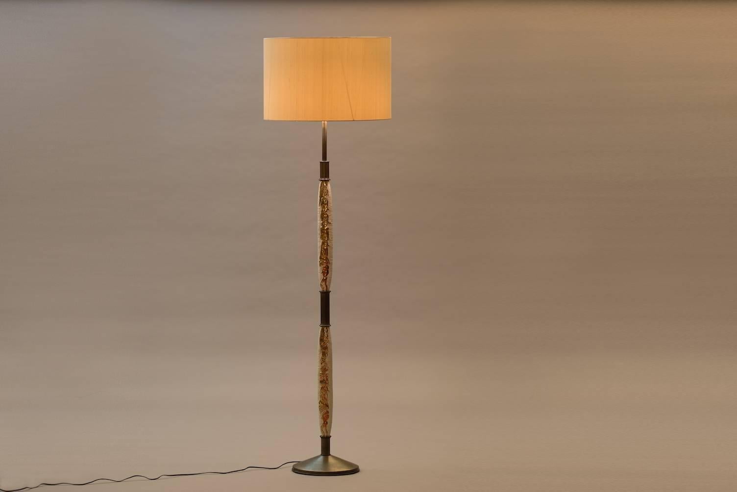 Floor lamp with Egyptian inspired ceramic motifs, brass and a new silk shade.
Measures: Diameter 55 cm (shade).