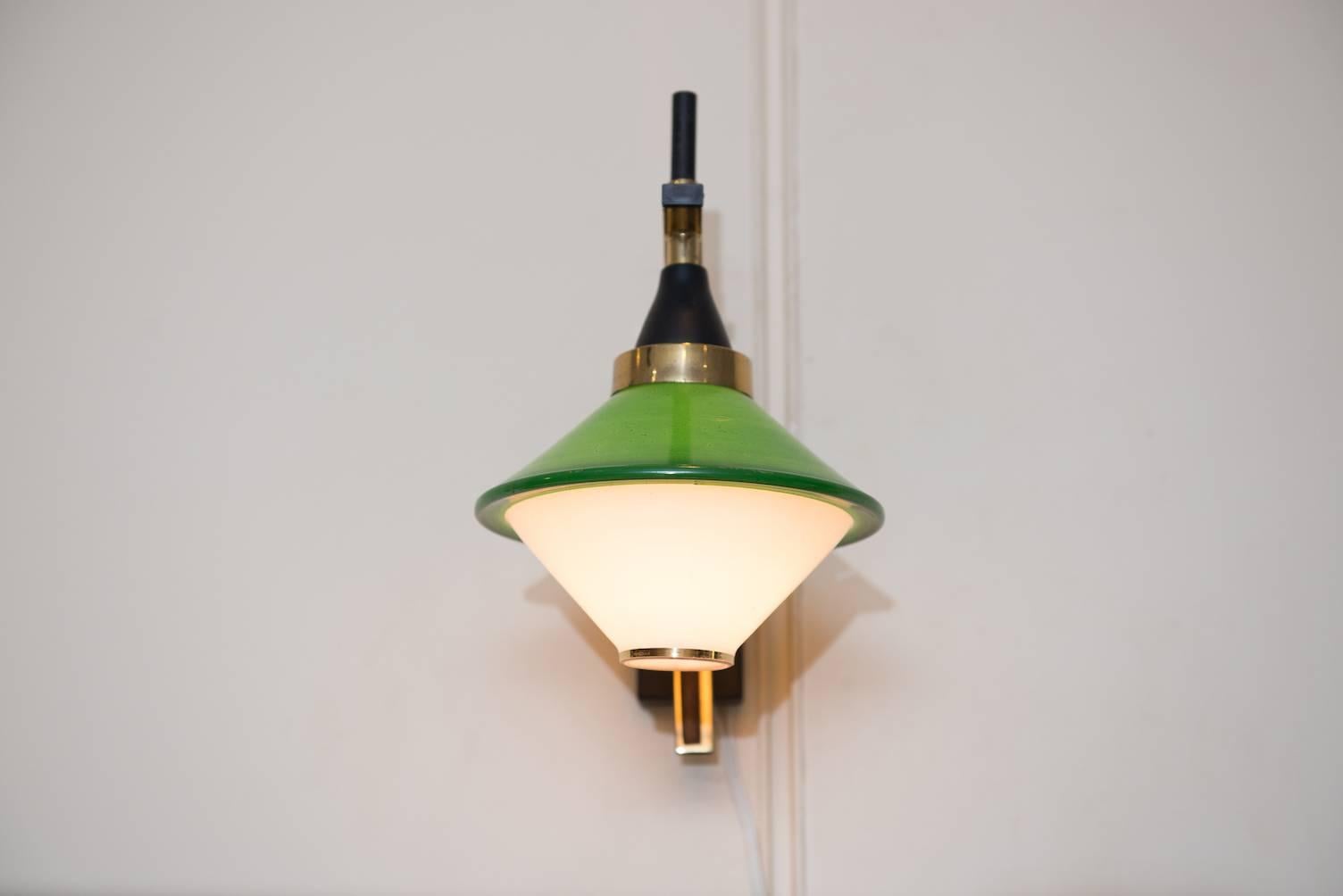 Mid-Century wall sconce in black painted metal, brass, wood and a green and opaline glass shadow.