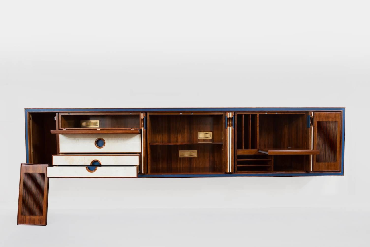 One of the kind large rosewood and parchment suspended sideboard with retractable doors, drawers and space for installation of speakers on the sides, blue leather details on doors and drawers.