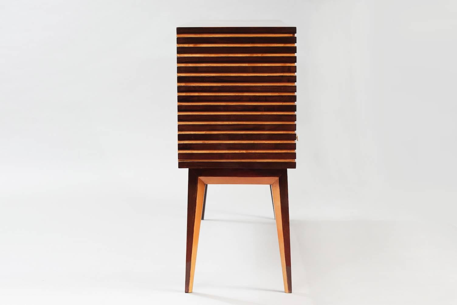 Rosewood and sycamore striped sideboard with display area and four drawers, brass door handles.