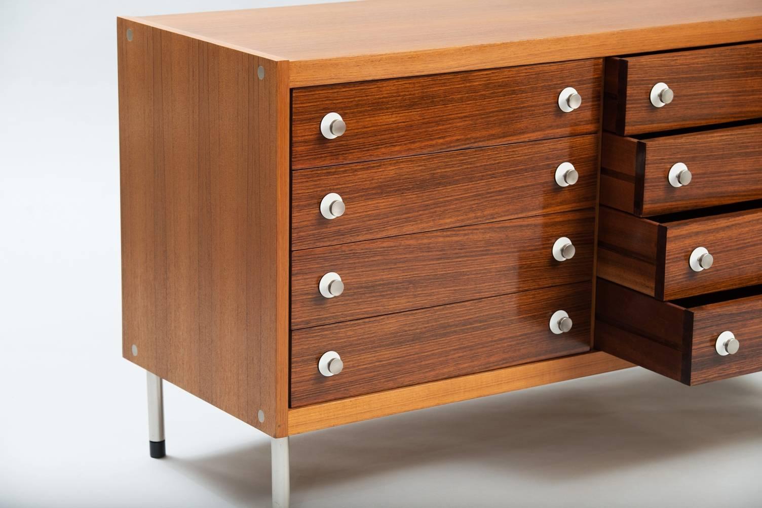 Rosewood and teak chest of drawers, legs in stainless steel and drawer handles in stainless steel and formica.