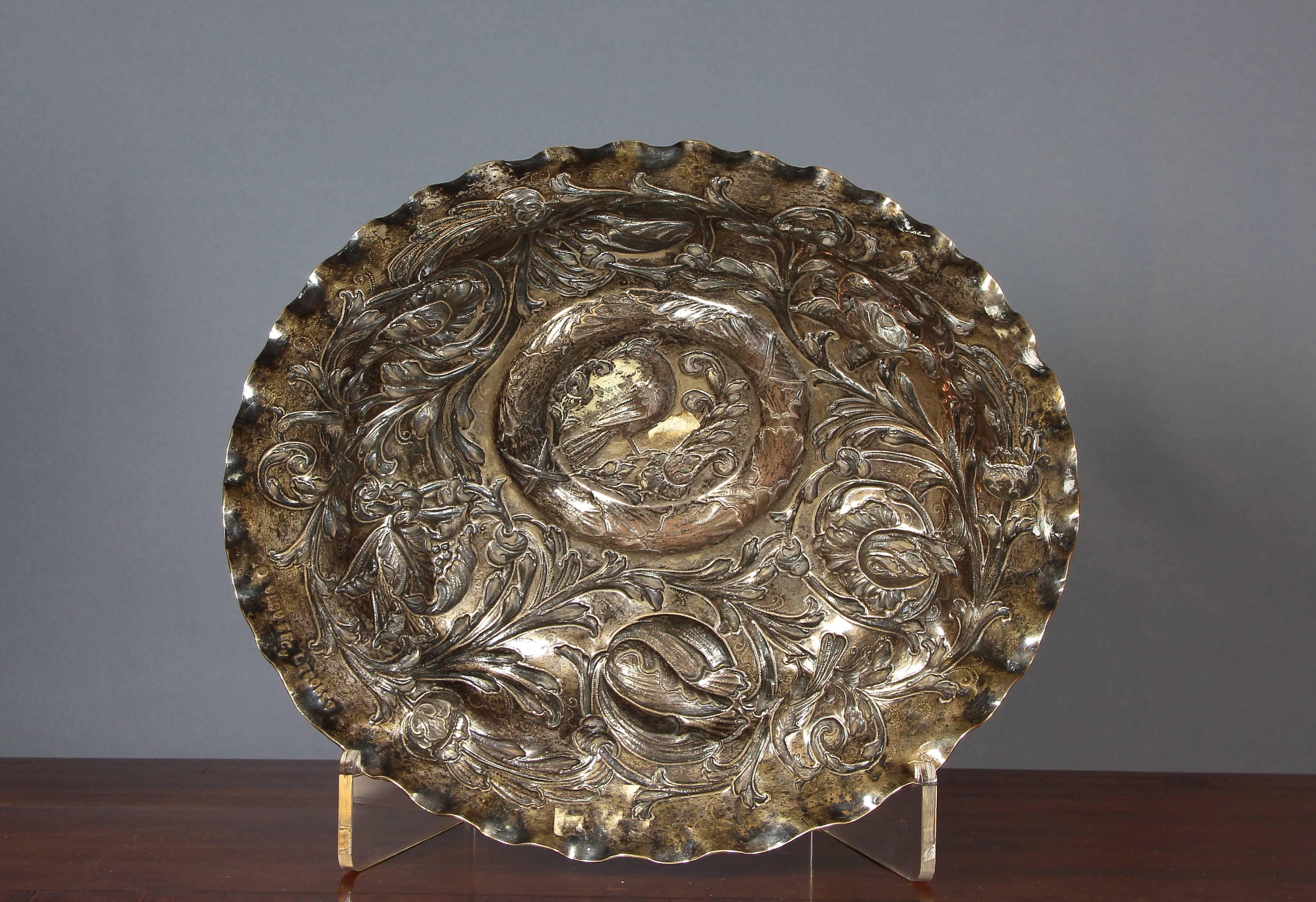17th-18th century silver tray.
In the center a pheasant inside a laurel and floral elements interlacing pheasants on the edge
Family mark 
