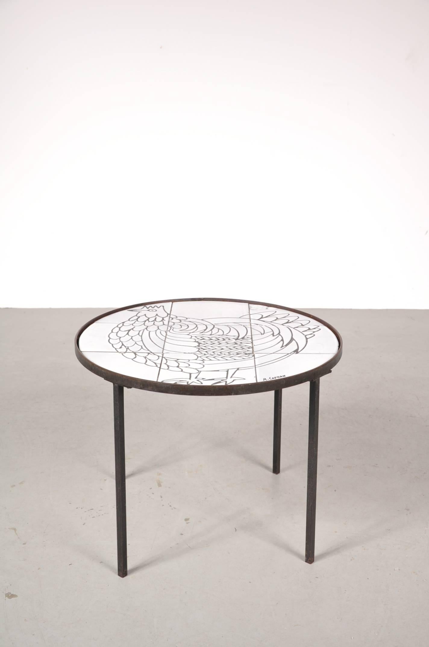 Stunning side table by Roger Capron, manufactured in France around 1950.

The table has a metal base and a beautiful ceramic top. The top consists of nine ceramic tiles with a unique drawing of a rooster and a hand written signature 