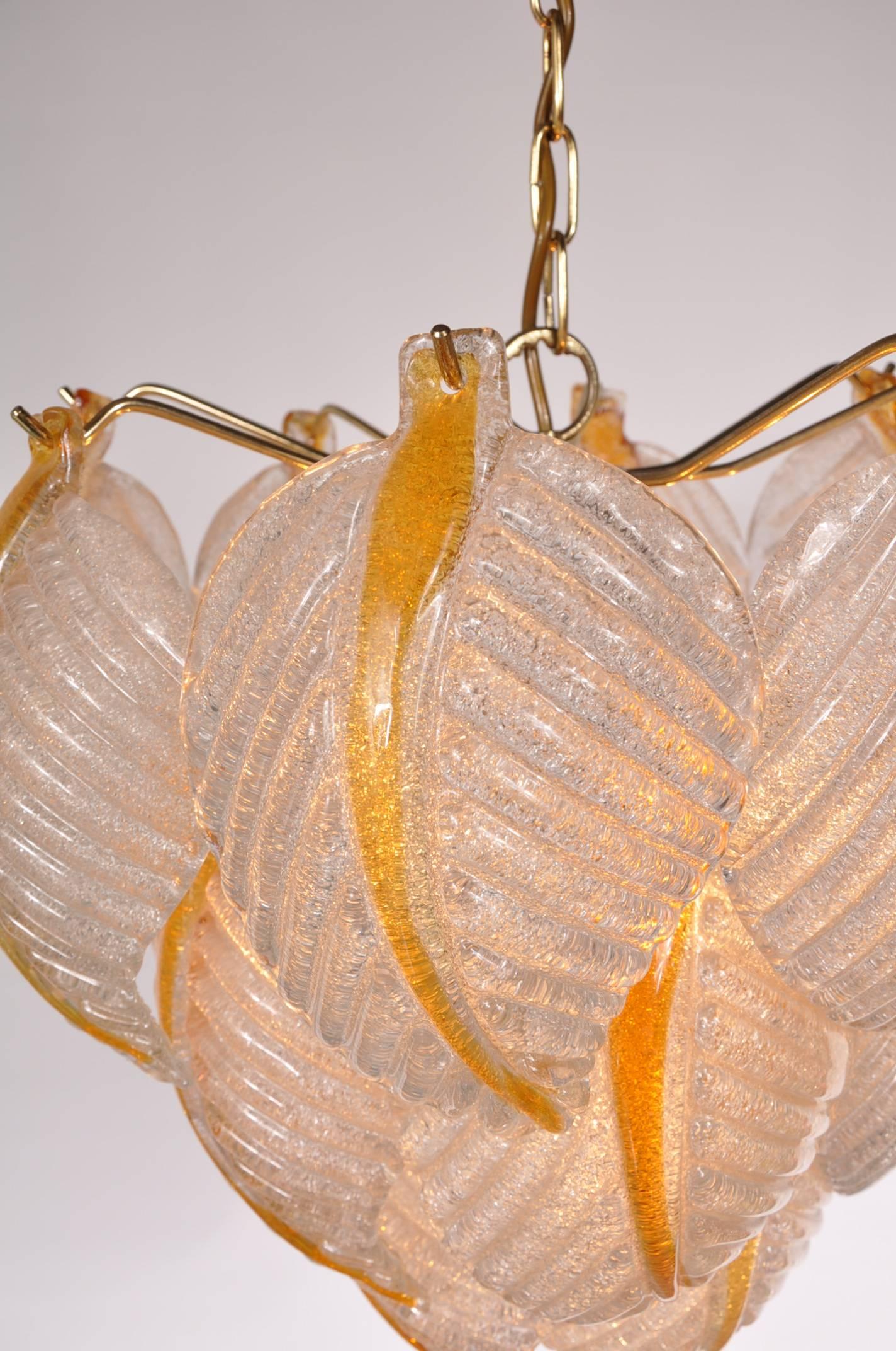 Eye-catching murano glass ceiling lamp by Mazzega, manufactured in Italy around 1960.

This stunning piece consists of several high quality murano glass leaves, held together with brass arms. This unique structure gives it a beautifull appearance