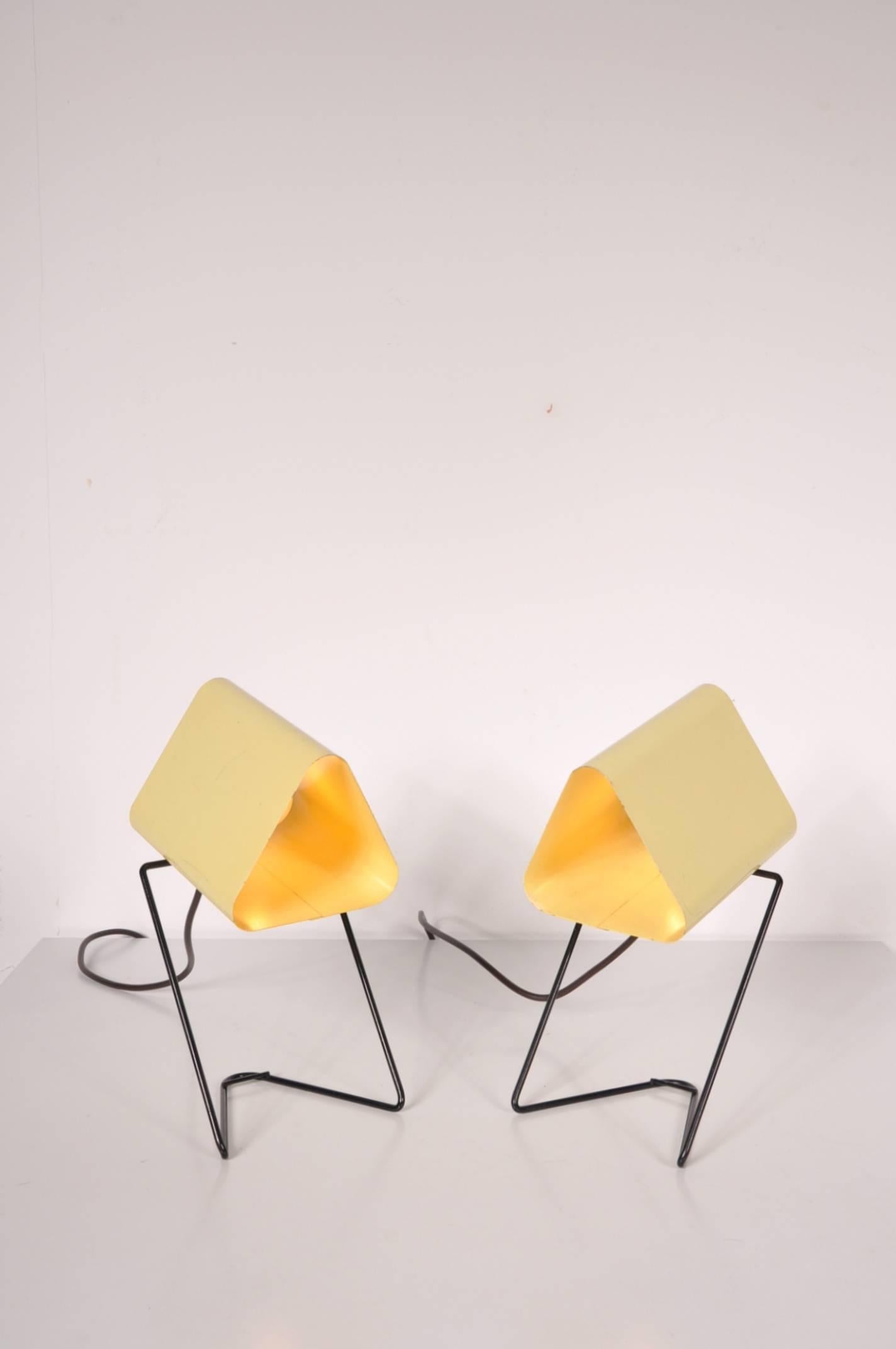 Beautiful set of two small table or bed lamps by Louis Kalff, manufactured by Philips in the Netherlands around 1950.

These eye-catching lamps are made of high quality black lacquered metal with yellow lacquered metal hoods. Together with their