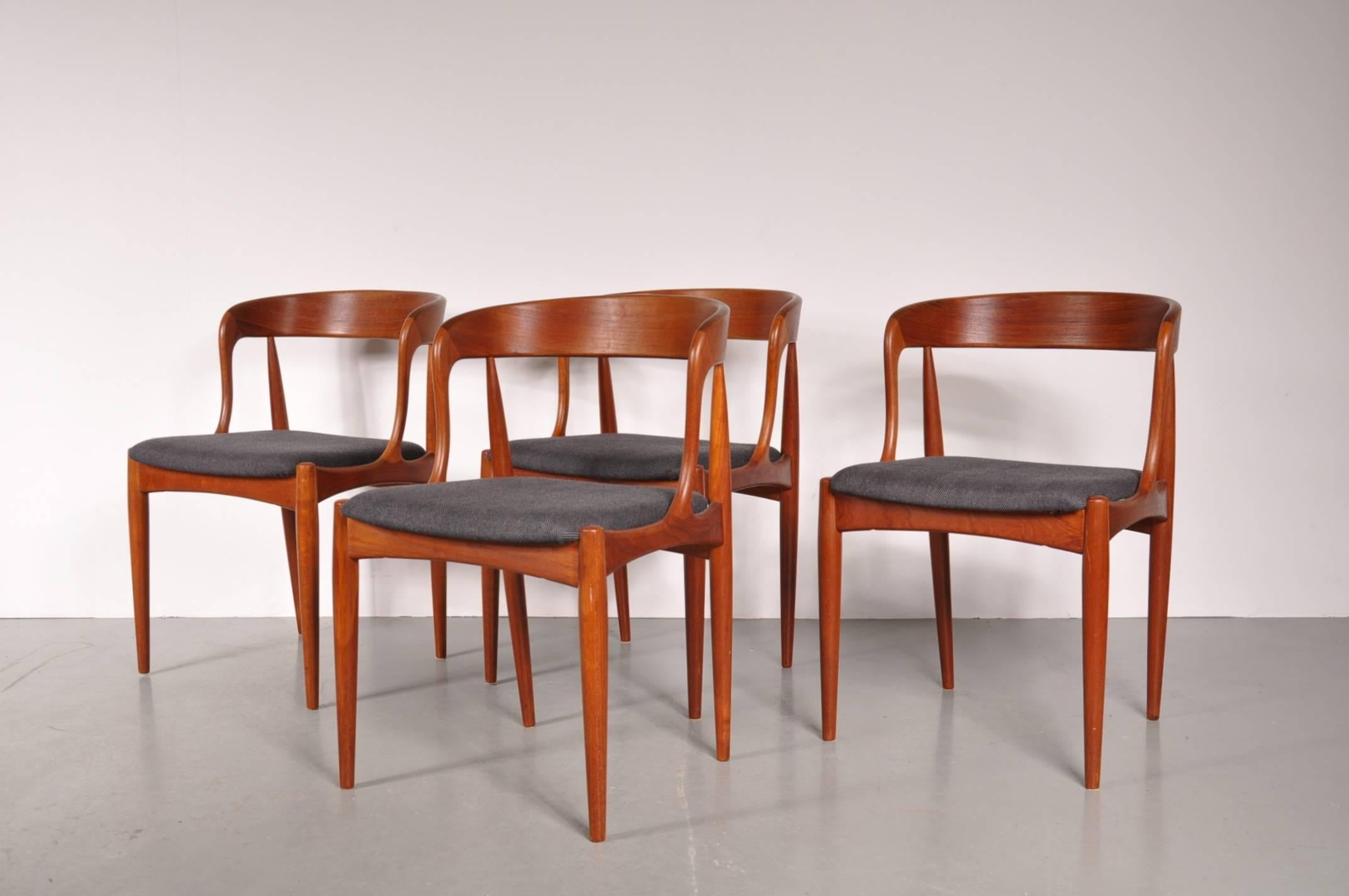 Beautiful set of four teak dining chairs by Johannes Andersen, manufactured by Uldum Mobelfabrik in Denmark around 1950.

These stunning pieces have a high quality teak base with beautiful organic shaped backrests. Together with the grey fabric
