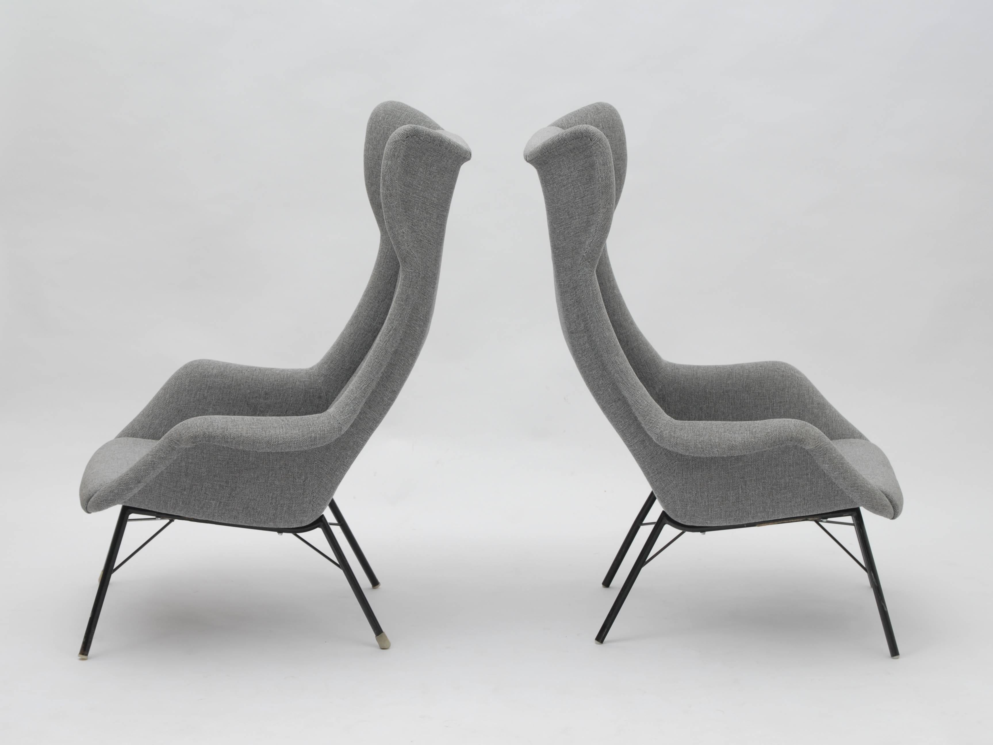 Stunning wingback easy chairs by Miroslav Navratil, manufactured in Czech by Cesky Nabytek around 1950.

These iconic chairs have a high quality metal base and new grey fabric upholstery. Their high backrests make them unique and very comfortable.