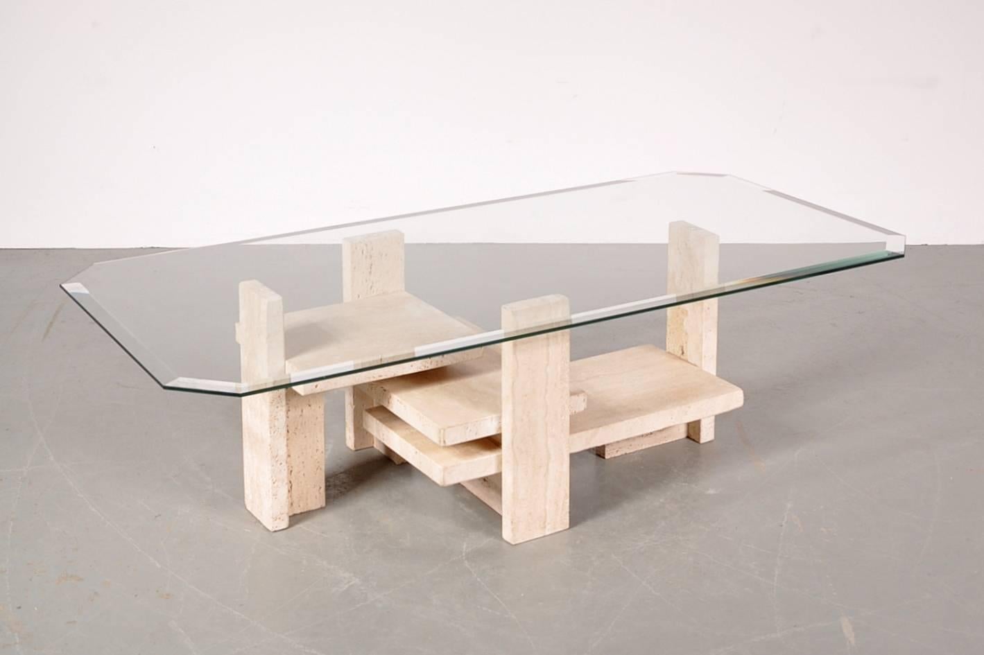 Amazing sculptural coffee table by Belgian artist Willy Ballez, circa 1980.

This unique piece has a high quality, sculptural design travertine base with a beautiful quality glass top. It would make a true eyecatcher in any modern interior.

In