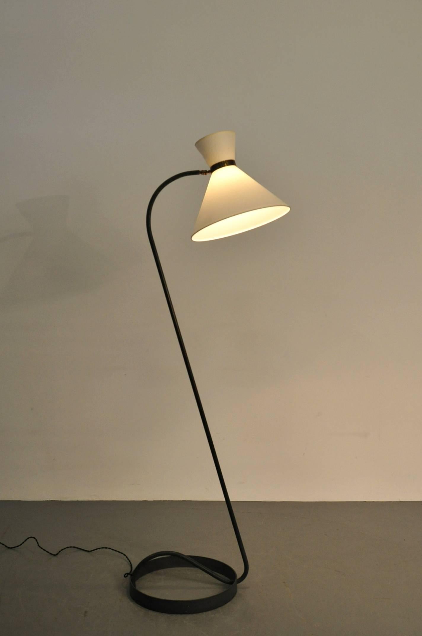 Luxurious floor lamp made by Maison Lunel in France, circa 1950.

It has a high quality metal base and slightly curved arm. The white fabric hood is connected by a beautifully crafted brass piece of armature, all together giving making this piece