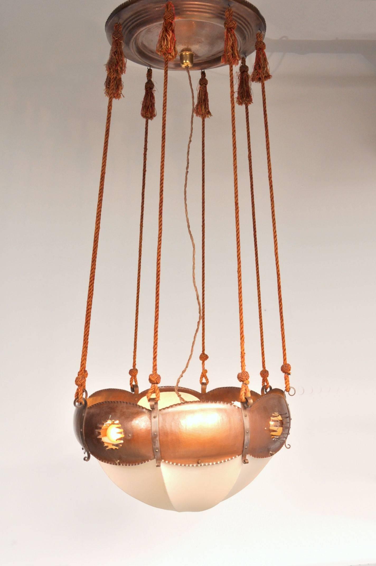 Eye-catching ceiling lamp designed and manufactured by Winkelman & Van der Bijl, manufactured in the Netherlands, circa 1925.

This stunning piece is made of high quality openworked and chased copper with rope supports and a fabric shade. It has a