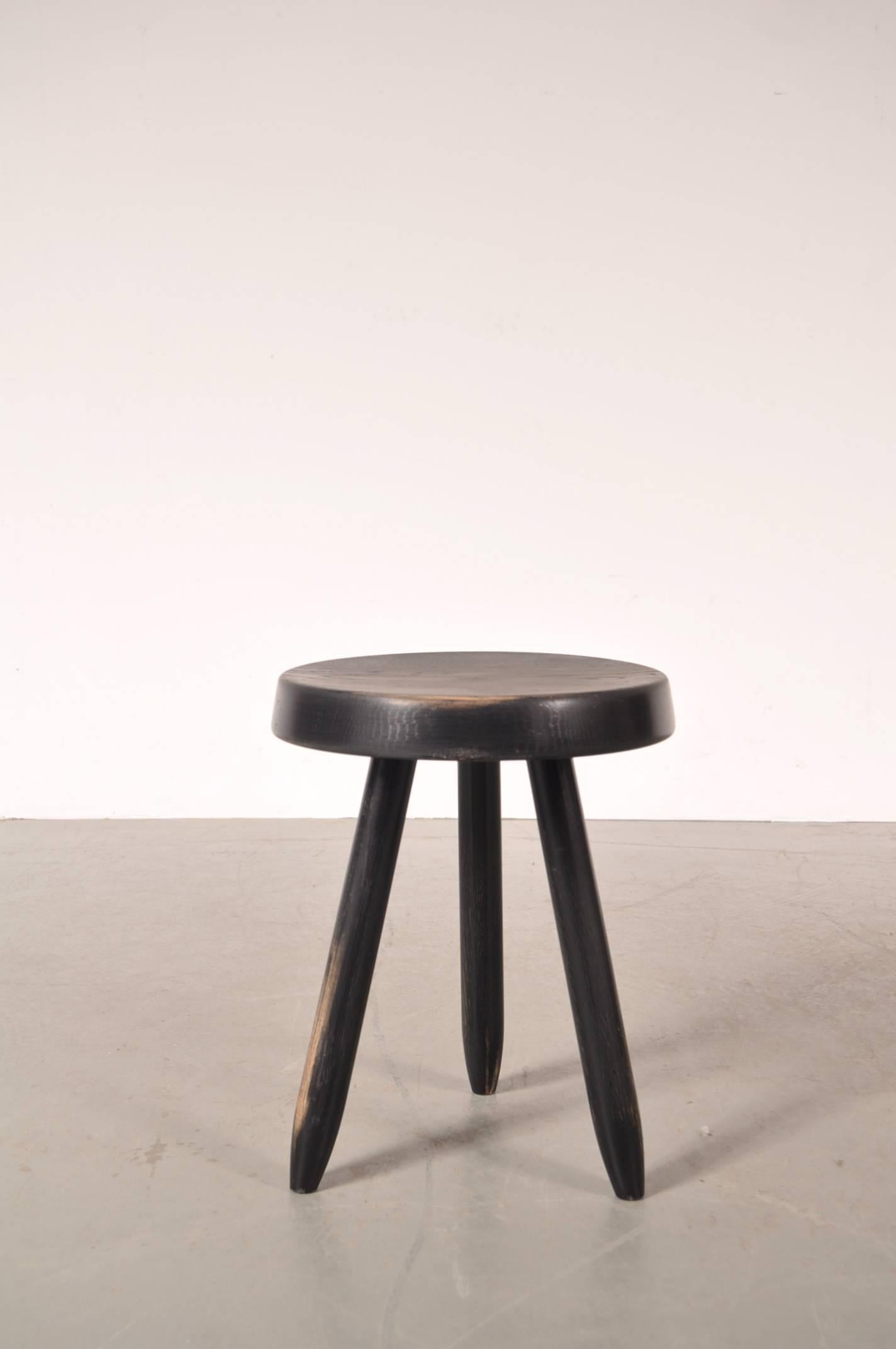 Beautiful high model stool by Charlotte Perriand for Les Arcs in France, circa 1950.

This lovely piece is made of black ebonized wood and has a round seat on a tripod base. These stools were designed for the apartments at a ski resort in Les