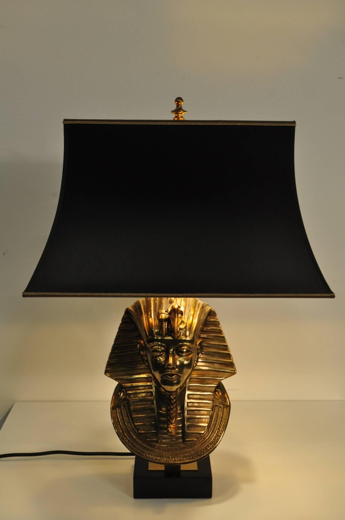 Eye-catching lamp with brass pharaoh sculpture, designed by Maison Jansen for Deknudt in Belgium around 1970.

This stunning piece is made of high quality 24-karat gold-plated brass on a black marble base. It has a black fabric hood with beautiful