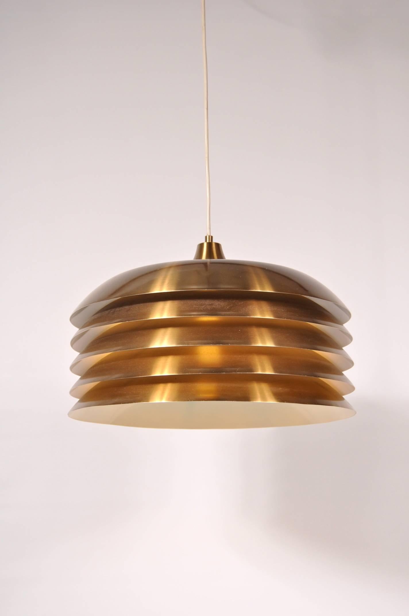 Stunning hanging lamp designed by Hans-Agne Jakobsson, manufactured by AB Markaryd in Sweden, circa 1960.

This amazing lamp is made of beautiful quality brass. It has a five-layered hood, making it a highly recognizable Jakobsson piece. This