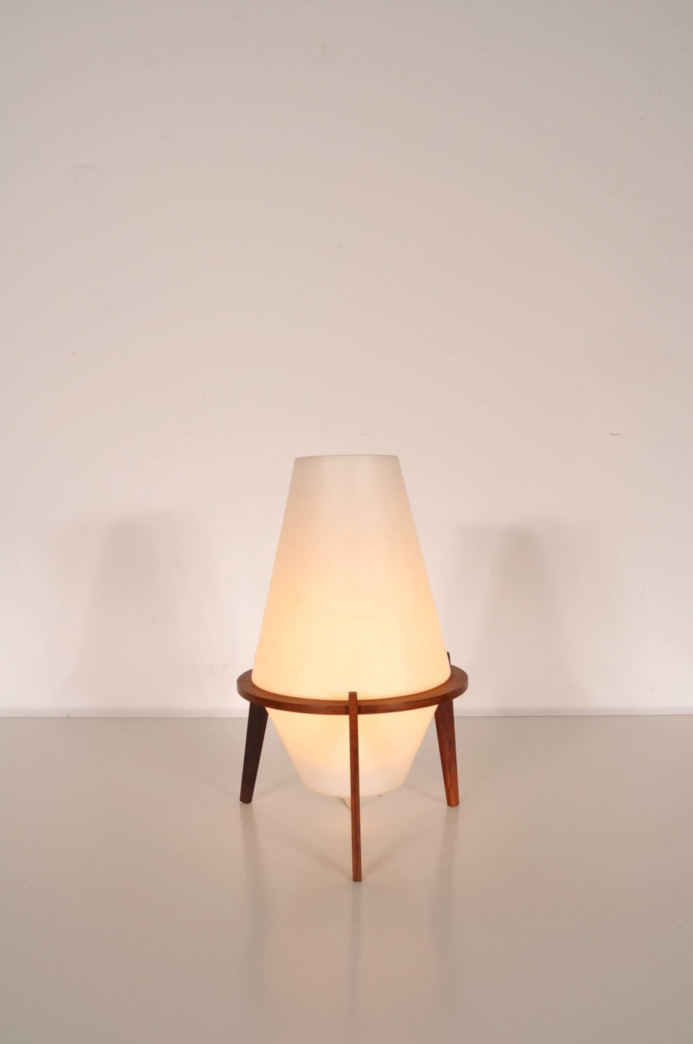 Rare table lamp by Fog & Mørup, manufactured in Denmark around 1950.

It is made of the most beautiful quality milk glass with a teak wooden base. The use of this material, together with it's unique design make it a truly valuable addition to any
