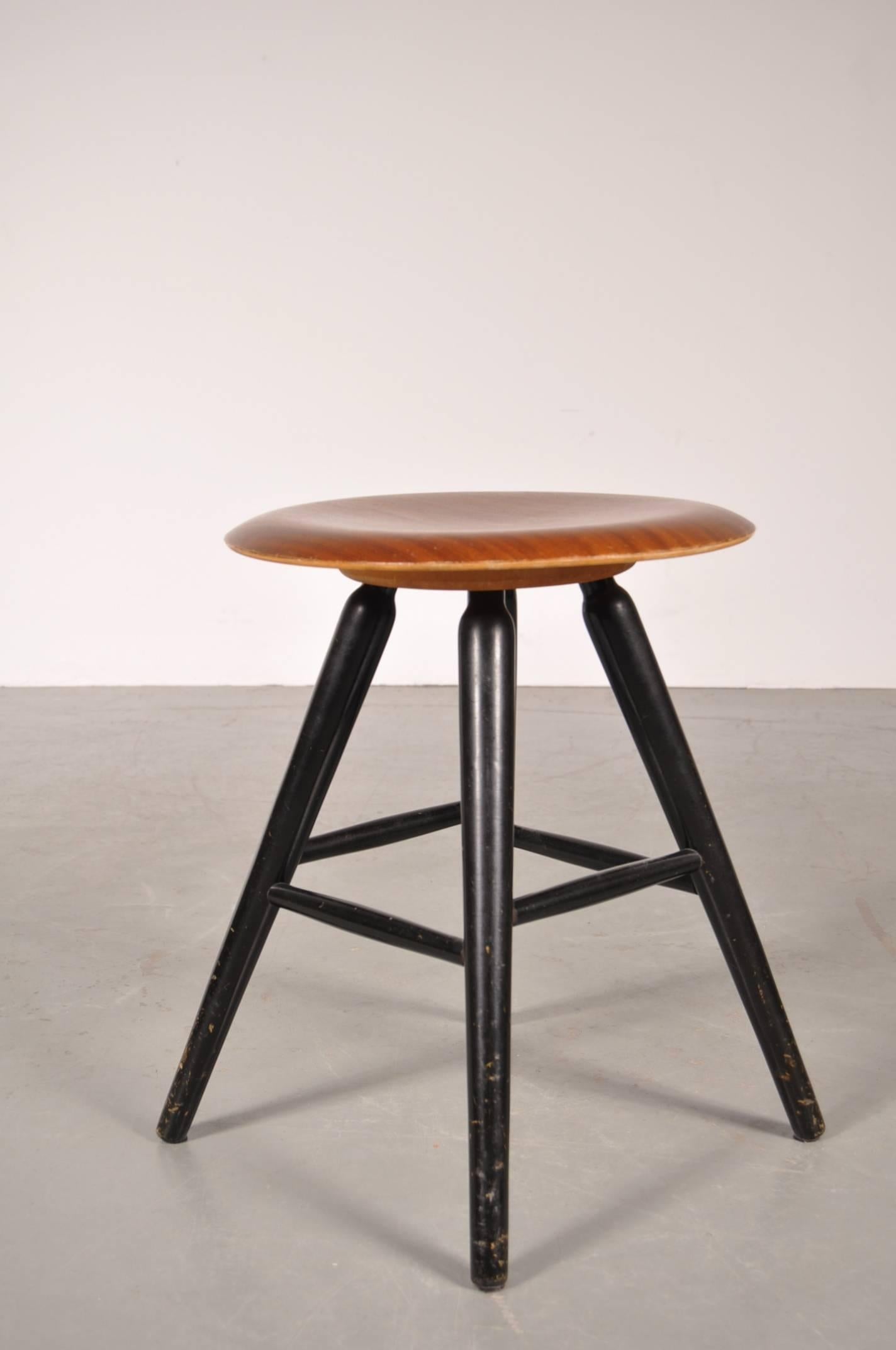 Beautiful wooden stool designed in the style of Ilmari Tapiovaara, manufactured around 1950.

The stool has a beautiful black wooden base with four legs and horizontal bars in different heights, creating extra stability as well as a nice design.