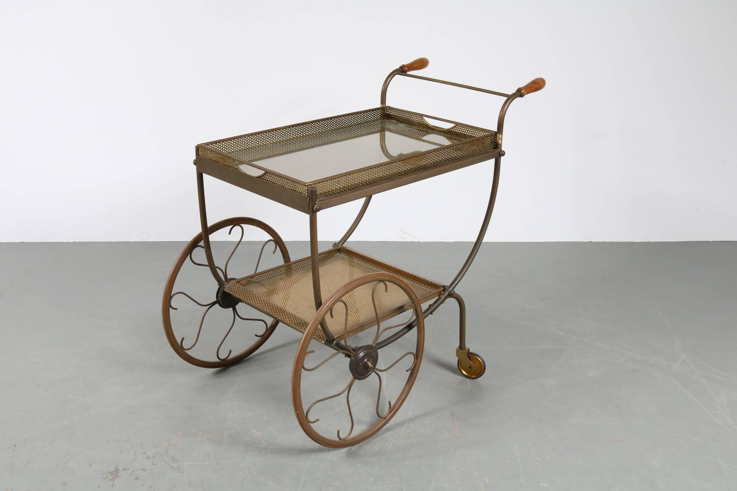 Luxurious tea trolley bar cart, manufactured in Sweden by Svenskt Tenn, circa 1950.

This elegant piece is made of beautiful quality brass, giving it beautiful classy appearance. It stands out with its amazing details in the design. It has two