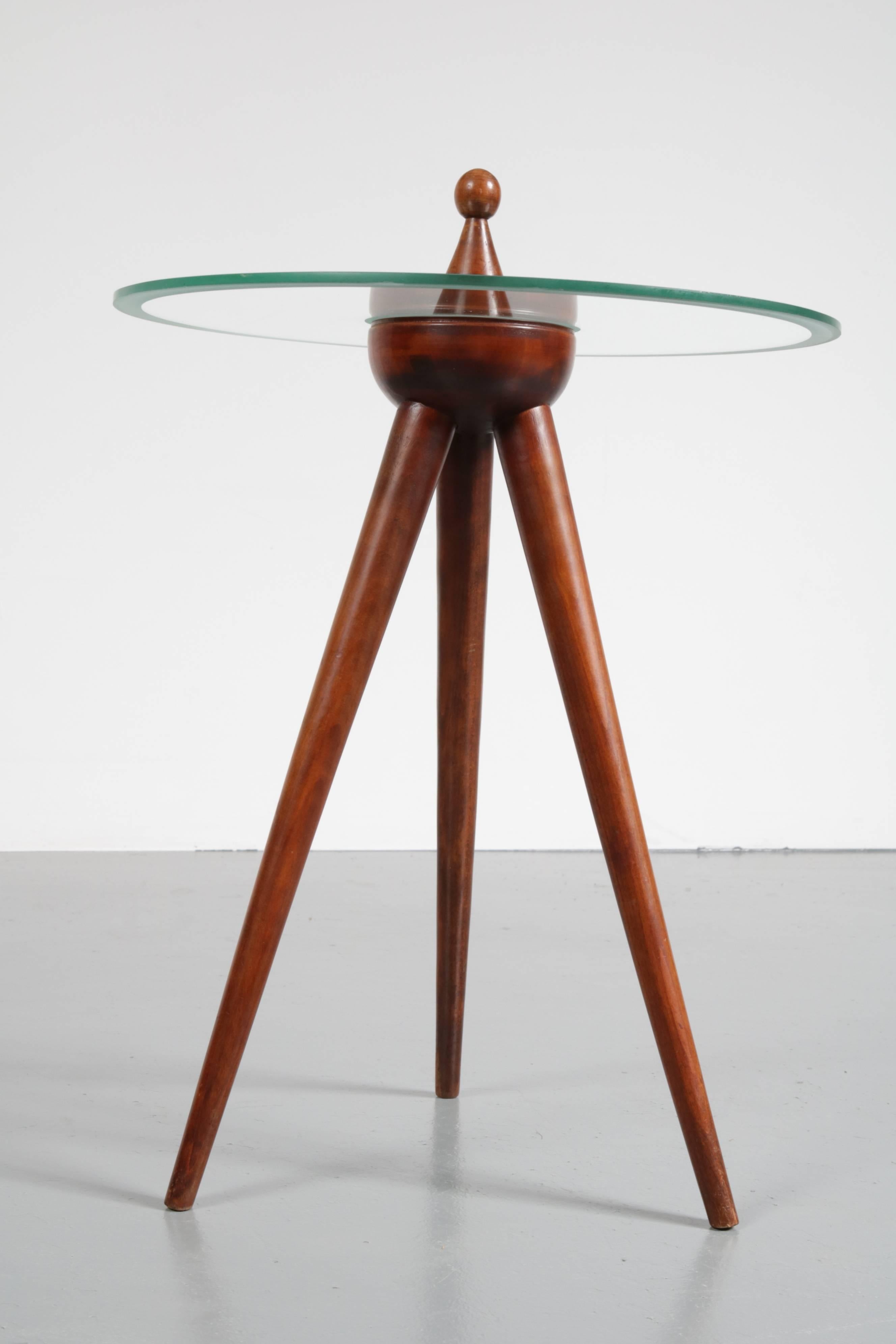 An elegant tripod side table made in Italy, circa 1950.

This rare find is made of high quality walnut wood with a round glass top. The edges of the top are beautifuly etched, creating an extra dimension to it's appearance. The tripod base is