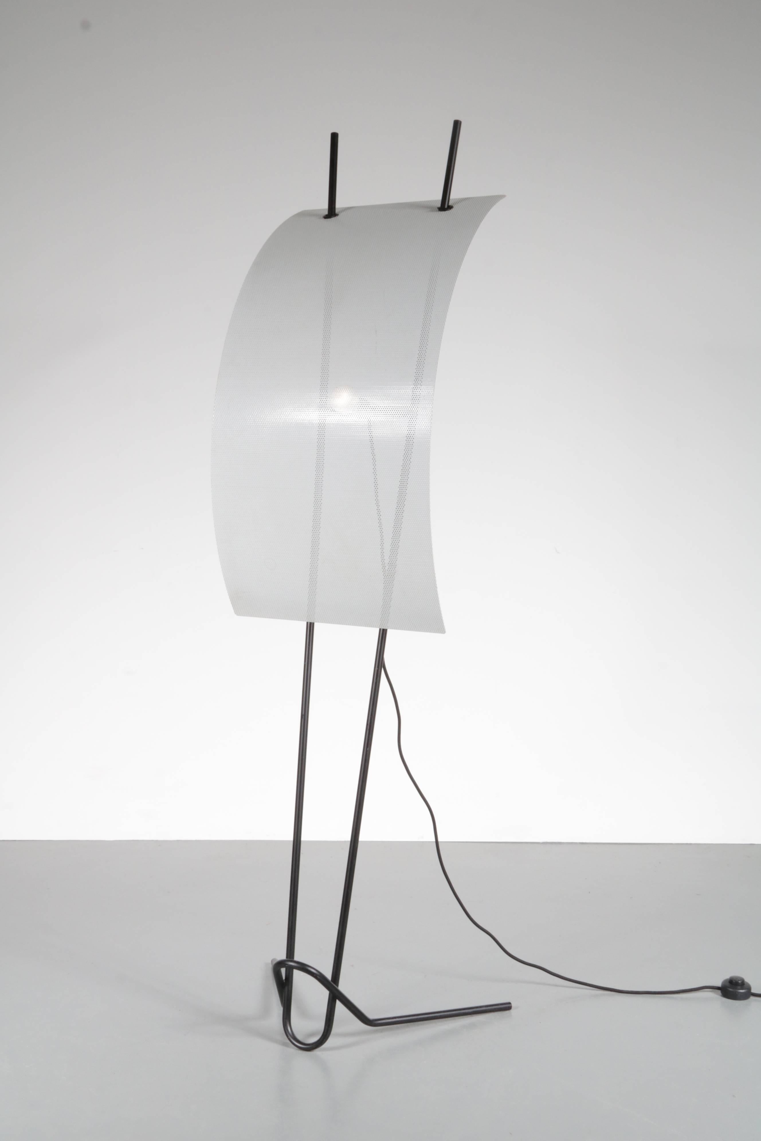 A large eye-catching floor lamp in the style of Mario Botta, manufactured in Italy, circa 1980.

This wonderful piece resembles the shape of a sail, with a black lacquered bent metal base and a big white perforated metal shade. The base pierces to