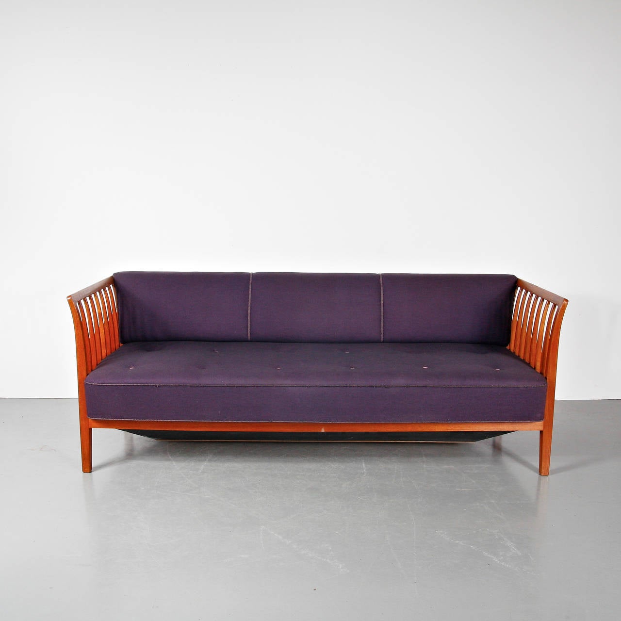 A rare, large sofa designed by Ludvig Pontoppidan, manufactured in Denmark around 1940 by himself.

This eye-catching sofa has a wonderful warm brown wooden frame with spokes in the armrests creating an amazing appearance. It has a nice, deep seat