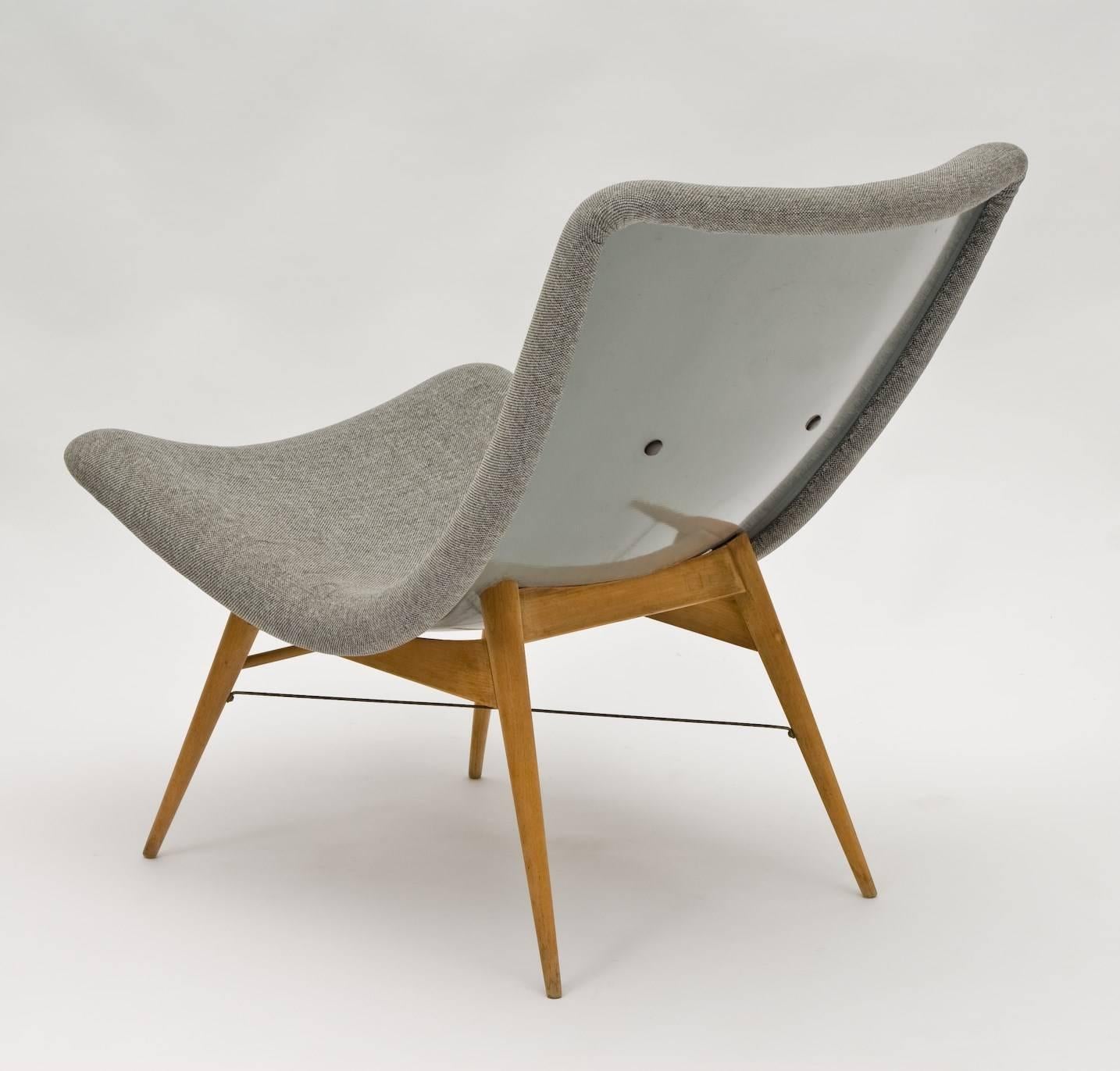 Stunning easy chair by Miroslav Navratil, manufactured  in Czech by Cesky Nabytek in 1959.

This iconic piece still has the original wooden base and a high quality fiberglass shell seating with grey fabric upholstery. It is an amazing piece of