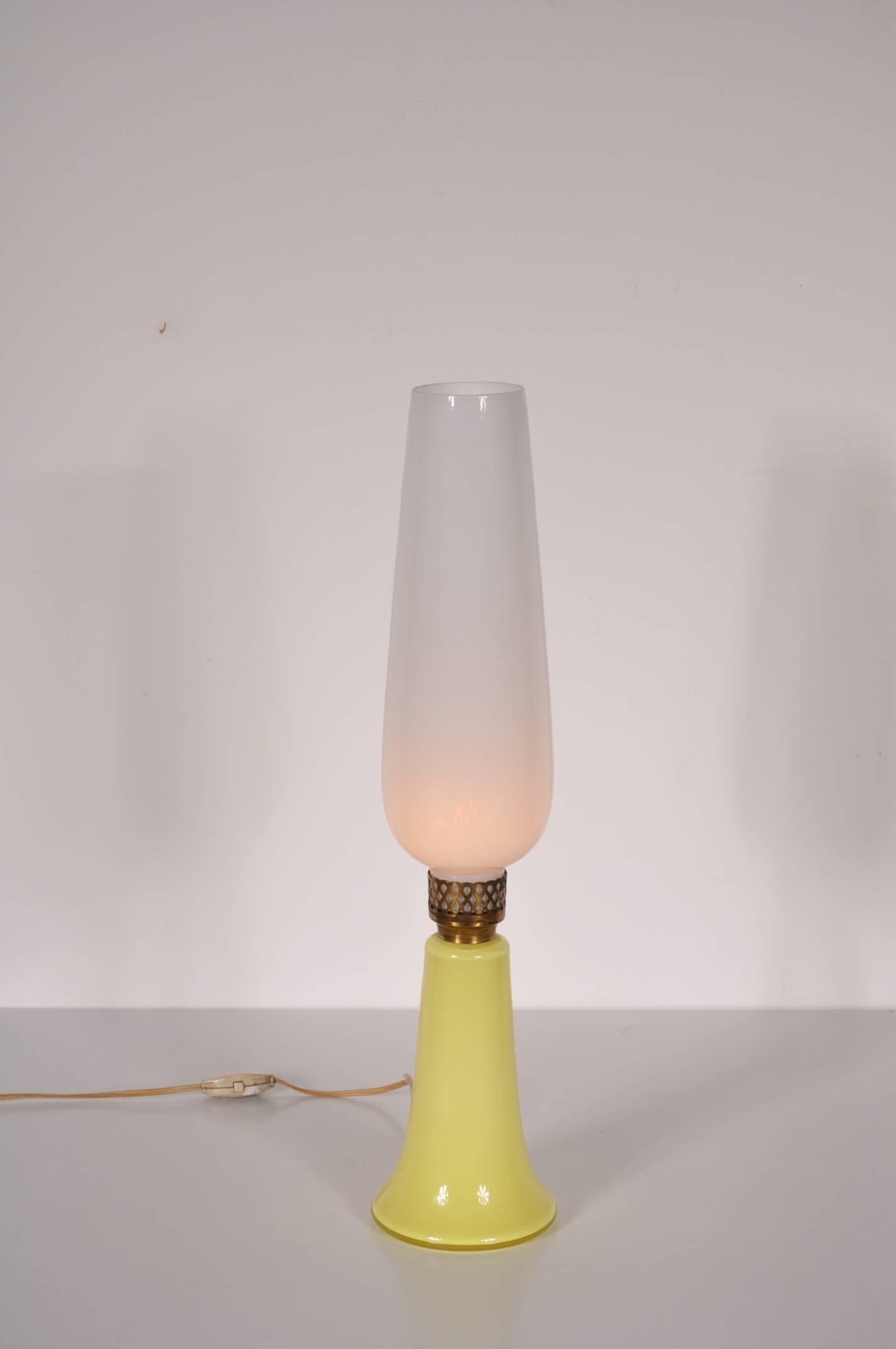 Beautiful table lamp by Venini, manufactured in Venice, Italy, circa 1950.

This piece is made of high quality glass. It has a yellow glass and with brass details, giving it a unique and luxurious appearance. It is stickered and engraved.

In