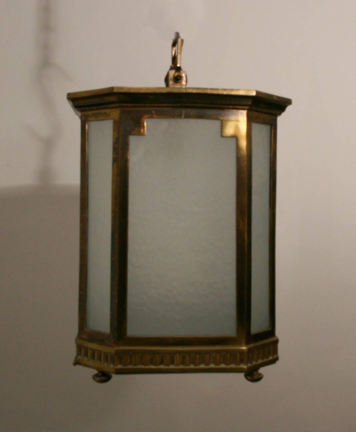 A pair of Art Deco, bronze and frosted glass lanterns.

 