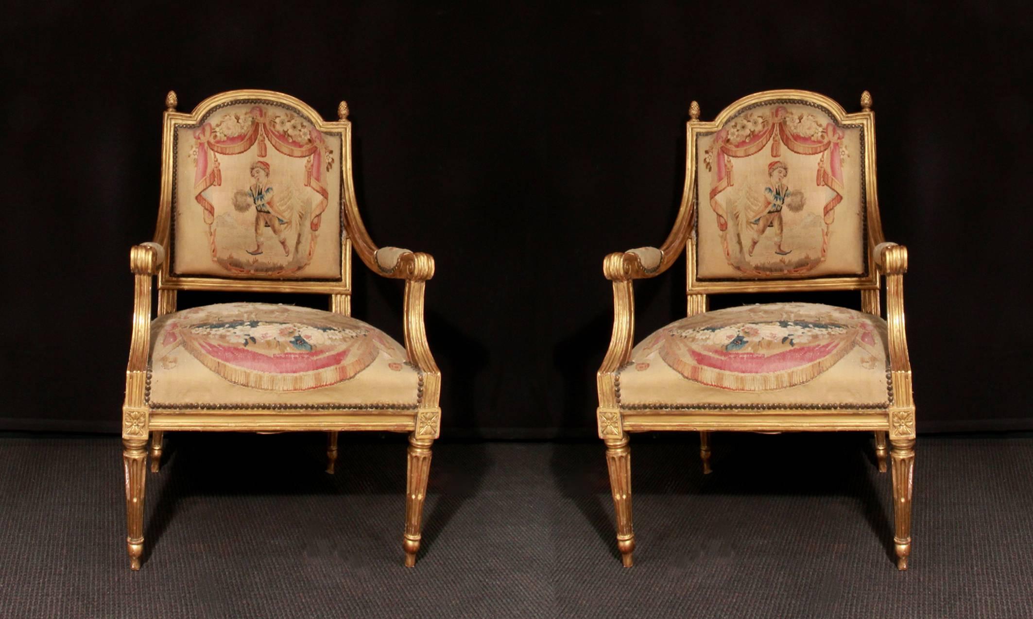 A set of four 18th century, carved giltwood chairs covered with original tapestry, French, circa 1780.

Seat height: 44.5cm. 

Can be sold in pairs (£3500 per pair).