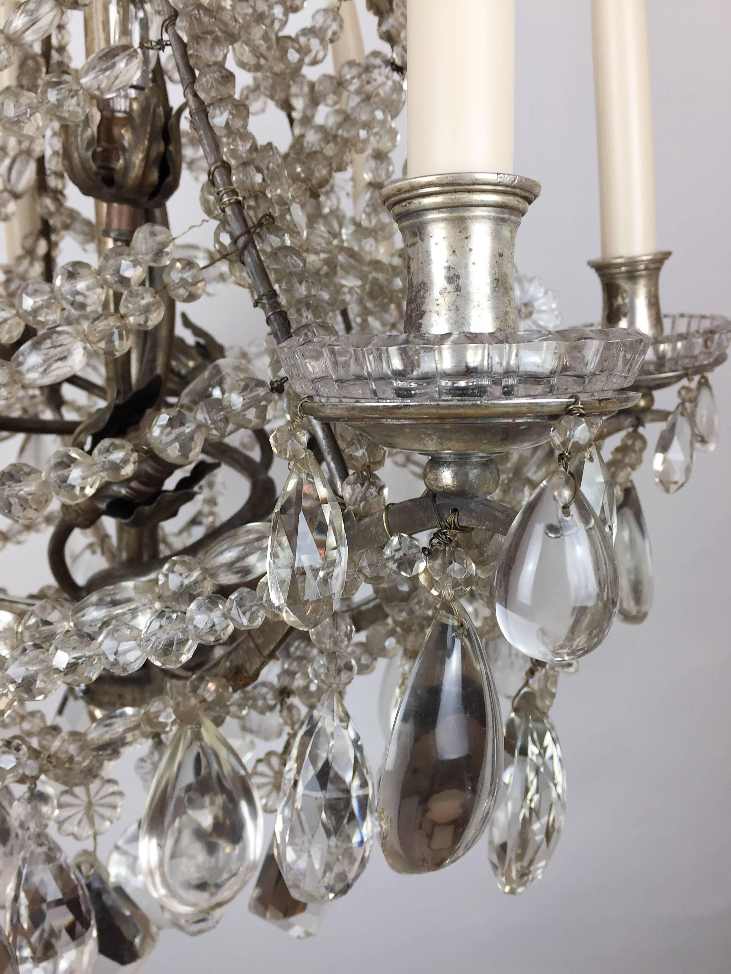 An unusual baguès silvered chandelier with a fine lattice work of beautifully cut beads in a rock crystal style. The top canopy takes the form of a crown of lattice work and the bottom is cut pendants of a beautiful lozenge shape facet.