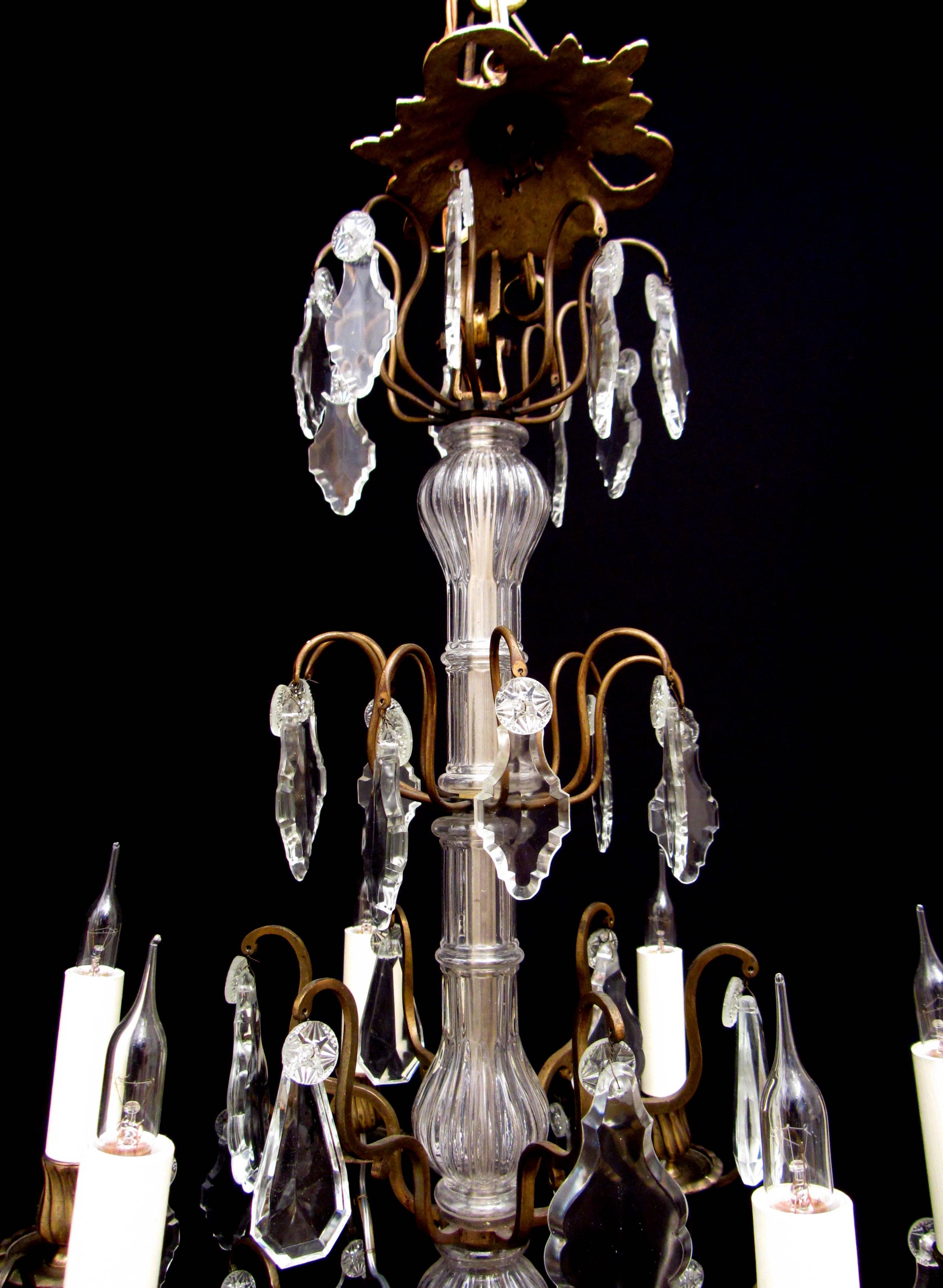A charming and nice quality French gilt brass and cut-glass chandelier. The cut-glass encased stem supports tiers of hung cut-glass plaques and six arms of light. Terminated by a solid glass ball.