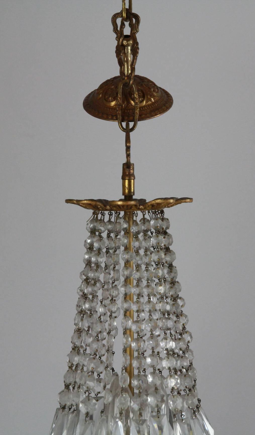 An English small bag and swag pendant chandelier, comprised of rectangular hand cut plaques threaded with hand cut button drops on an embossed gilt frame with ceiling dome and chain.